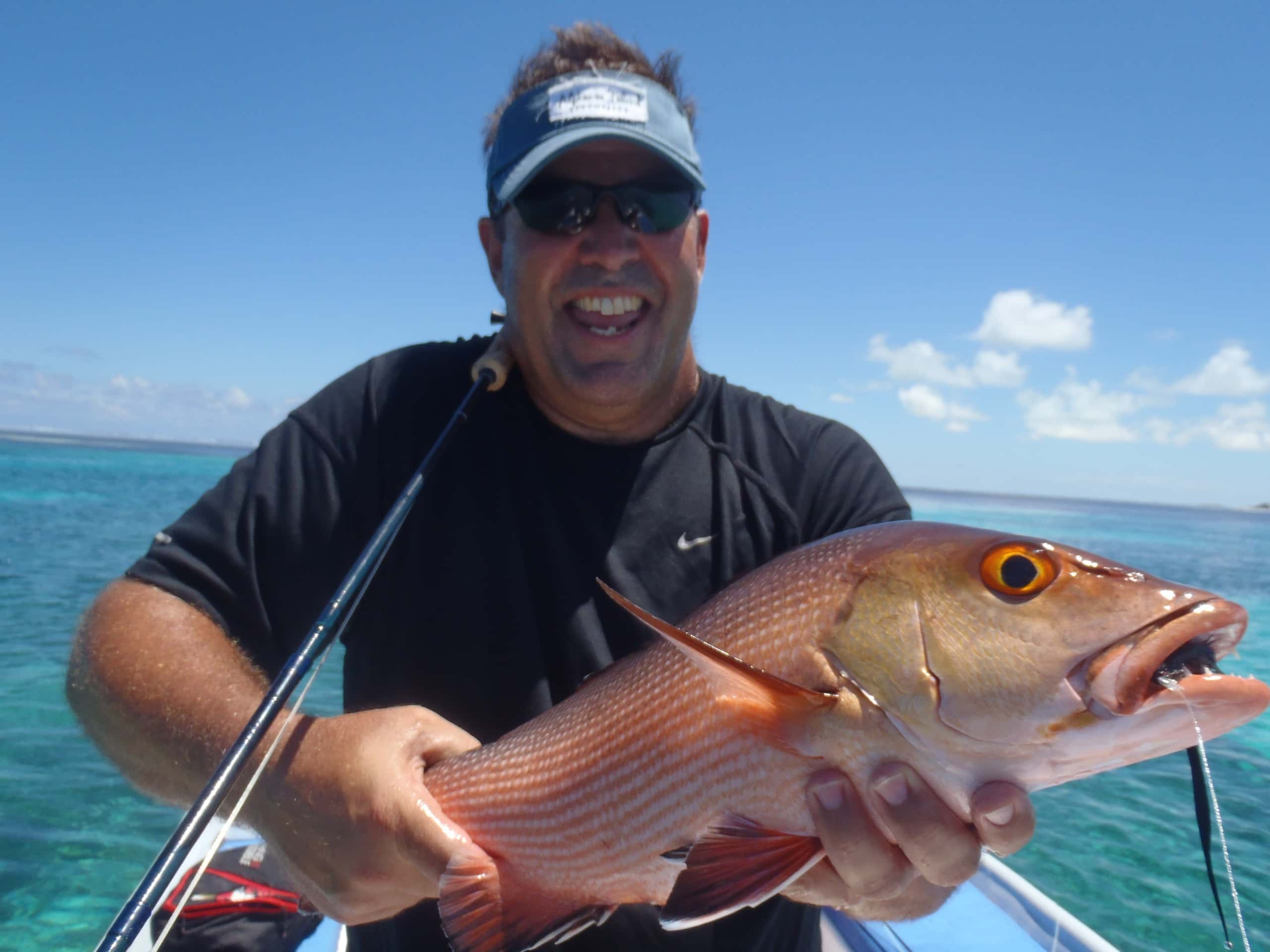 A fish brought aboard over blue water off the Mozambican coast
